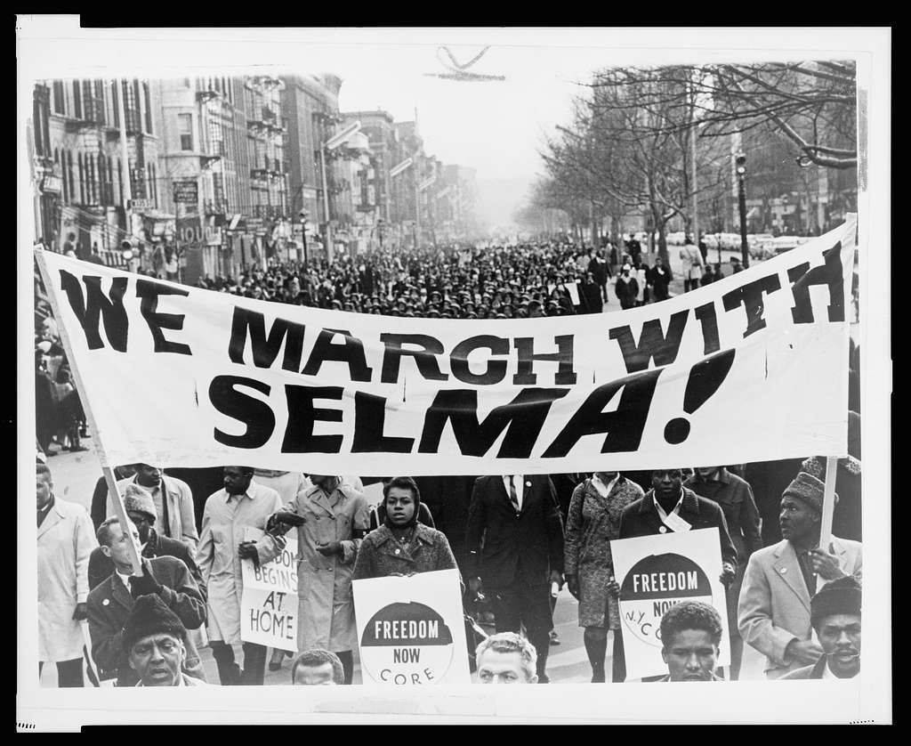 “Marchers Carrying Banner Lead Way as 15,000 Parade in Harlem” © New York World-Telegram and the Sun Newspaper; Stanley Wolfson, photographer; public domain