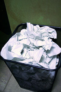 trash can filled with crumpled papers