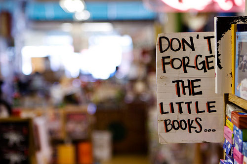 Sign reading Don&#039;t Forget the Little Books in used bookshop