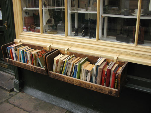 Books in a flowerbox outside a shop