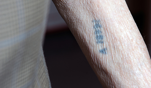 Photo of Holocaust Tattoo © Marvin Lynchard, Department of Defense; public domain