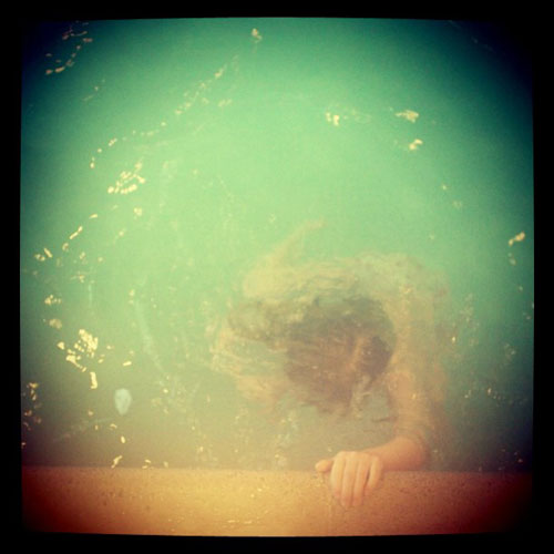 Little girl underwater in a swimming pool